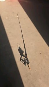 black fishing rod with ultra cast 554 reel