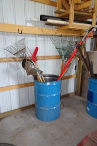 Barrel with Yard Tools - Rakes, Shovel