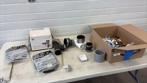 Plumbing supply a lot including pressure vacuum breaker hose and brackets and assorted supplies