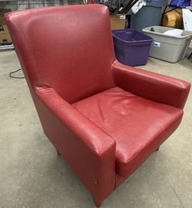 A red leather (or faux-leather) club chair  sometimes called an armchair or lounge chair.
