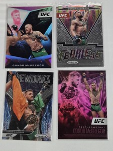 Lot of 4 Conor McGregor UFC Sports Cards featuring Fearless, Black, and Fireworks sets with Featherweight and Welterweight details.