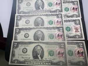 Seven Uncirculated 1976 $2.00 Bills with stamps