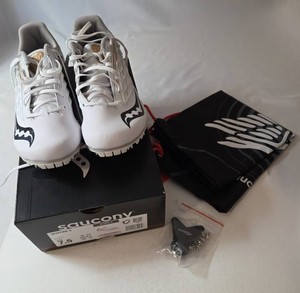 New in box SAUCONY Spit Fire 5 girls track shoes.  Size 7.5. White gold trim. Includes a carrying bag.