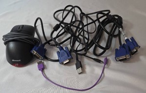 Computer mouse and cables.  The mouse is wired and the misc. cables include USB to C Cable and 15 pin VGA cables.