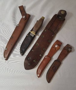 4 Leather Knife Sheaths and 1 Knife.