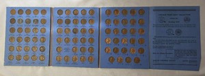 1 completed book of Pennies from 1941-1975 and an empty book of State Quarters
