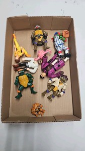 Lots of 90s Teenage Mutant Ninja Turtles toy action figures.