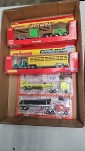 Lot of 4 164th die cast semi tractor-trailers major at hand road champs in the package.