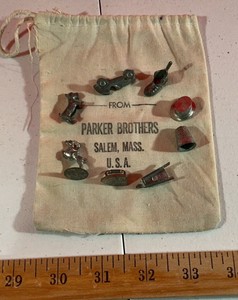 Vintage Parker Brothers monopoly game pieces and cloth bag toy