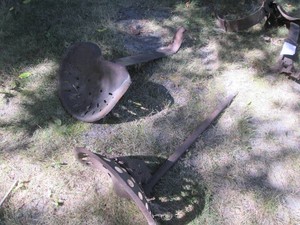 Pair of cast iron tractor seats on ...
