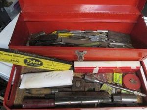 Red metal toolbox containing a wide...