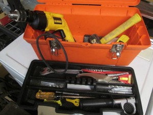 Orange toolbox containing Dewalt 1...