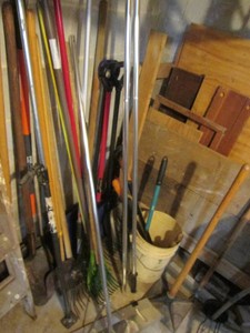 Corner lot of shovels, rakes, coppe...