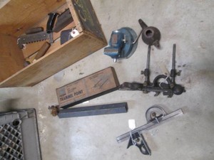 Wood crate filled with router parts, protractor and more