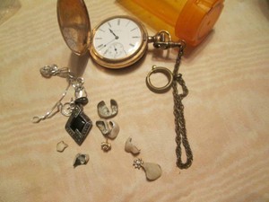 Pocket watch, jewelery and teeth with fillings,