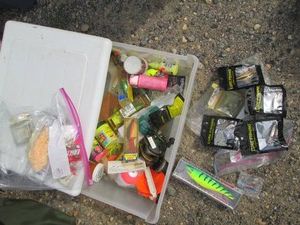 Plastic storage drawer containing a wide variety of fishing lures and equipment