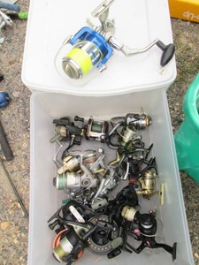 Storage drawer of assorted fishing reels including Shimano, Winchester and more