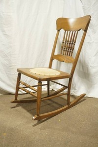 vintage mid-century spindle back rocking chair with an upholstered seat center