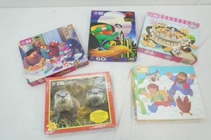 group of childrens puzzles that have been opened