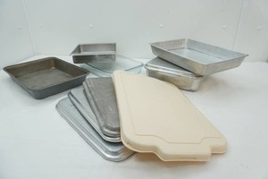 variety of cake pans and lids, not all pans have a lid