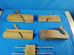 Collection of vintage wooden woodworking hand planes and a wooden marking gauge.
