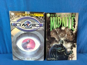 Two DC Comics publications The OMAC Project (Countdown to Infinite Crisis) on the left and Doctor Mid-Nite #2 (1999) written by Matt Wagner with art by John K. Snyder III