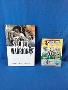 Marvel trade paperback for Secret Warriors Vol. 1 Nick Fury, Agent of Nothing on the left and a DC comic book for Superman