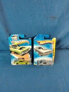 Two packaged 164 scale Hot Wheels 69 Dodge Coronet Super Bee die-cast muscle cars,