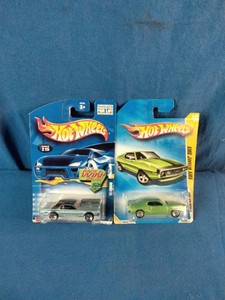 Two unopened 164 scale Hot Wheels die-cast cars on their original cardbacks