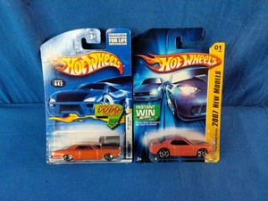 Two orange Hot Wheels die-cast cars in their original packaging
