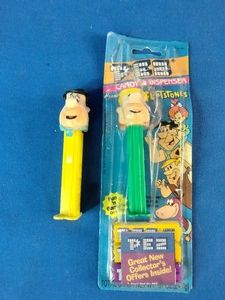 Two vintage The Flintstones PEZ candy dispensers featuring Fred Flintstone and Barney Rubble from Hanna-Barbera