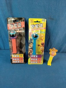 Collection of collectible PEZ candy and dispenser items,