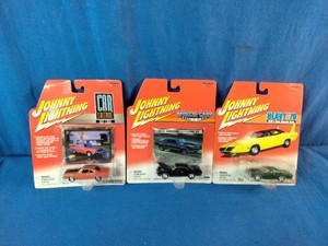 Three 164 scale Johnny Lightning die-cast muscle car blister packs from different classic series.