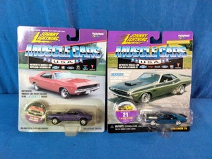 Two vintage Johnny Lightning Muscle Cars U.S.A. 164 scale die-cast toy cars still in their original blister packaging.