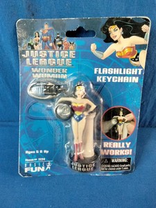 A vintage Basic Fun Justice League Wonder Woman Flashlight Keychain from 2005, still sealed in its original packaging