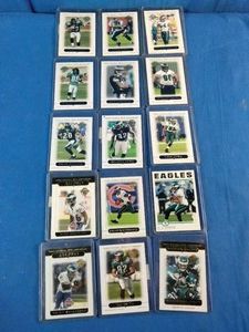 A collection of Philadelphia Eagles football trading cards in protective top loaders