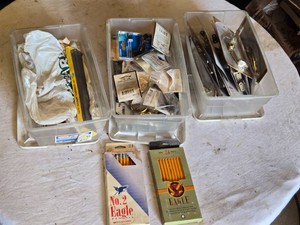 Assorted Hardware and Stationery Supplies with items such as grip fast 10-inch common spikes, hooks, hinges, friction lid supports, and other hardware pieces, along with two boxes of No. 2 Eagle pencils