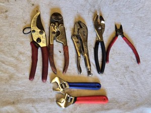 Assorted hand tools including pliers, adjustable wrenches, Vice Grip and a pair of shears