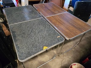 Folding tables with wooden and granite looking light wooden tops, silver legs, collapsible design - 1 has a very warped top