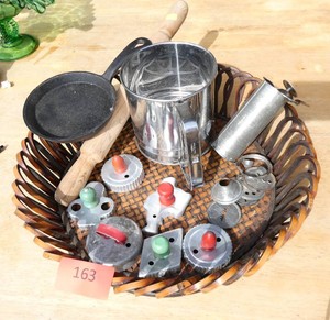 Vintage cookie cutters, frosting press, flour sifter, small cast iron pan and wood rolling pin