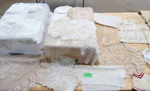 large group of handmade doilies and arm chair covers