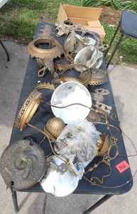 Table full of antique lamp parts