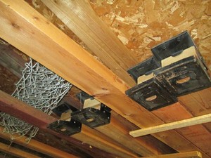 Content of Shed rafters including wood saw horses, misc metal flag poles, lumber and more