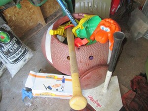 Football shaped toy and step-on garbage bin with assorted childrens toys and entertainment