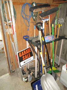 Freestanding yard tools organizer with a wide variety of outdoor tools