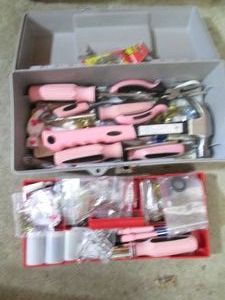 Small toolbox containing light pink hand tools plus household hardware and supplies