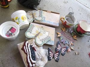 Collection of floral themed planters, stepping stones and decor