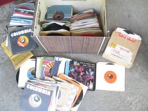 Cardboard banker box with a huge collection of 45s vinyl record albums