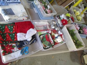 Smaller sized assorted storage containers with a wide variety of assorted seasonal home decor and supplies