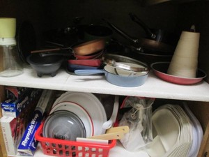 Various size frying pans, enamelware lids, aluminum foil, electric knife, vintage press and more